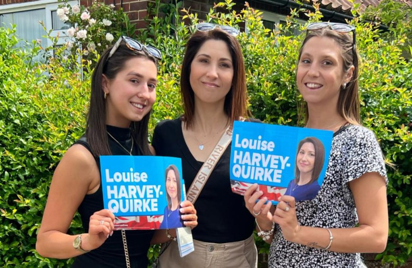 Louise with her daughters, who are holding campaign posters