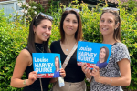 Louise with her daughters, who are holding campaign posters