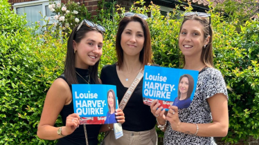 Louise with her daughters, who are holding campaign posters